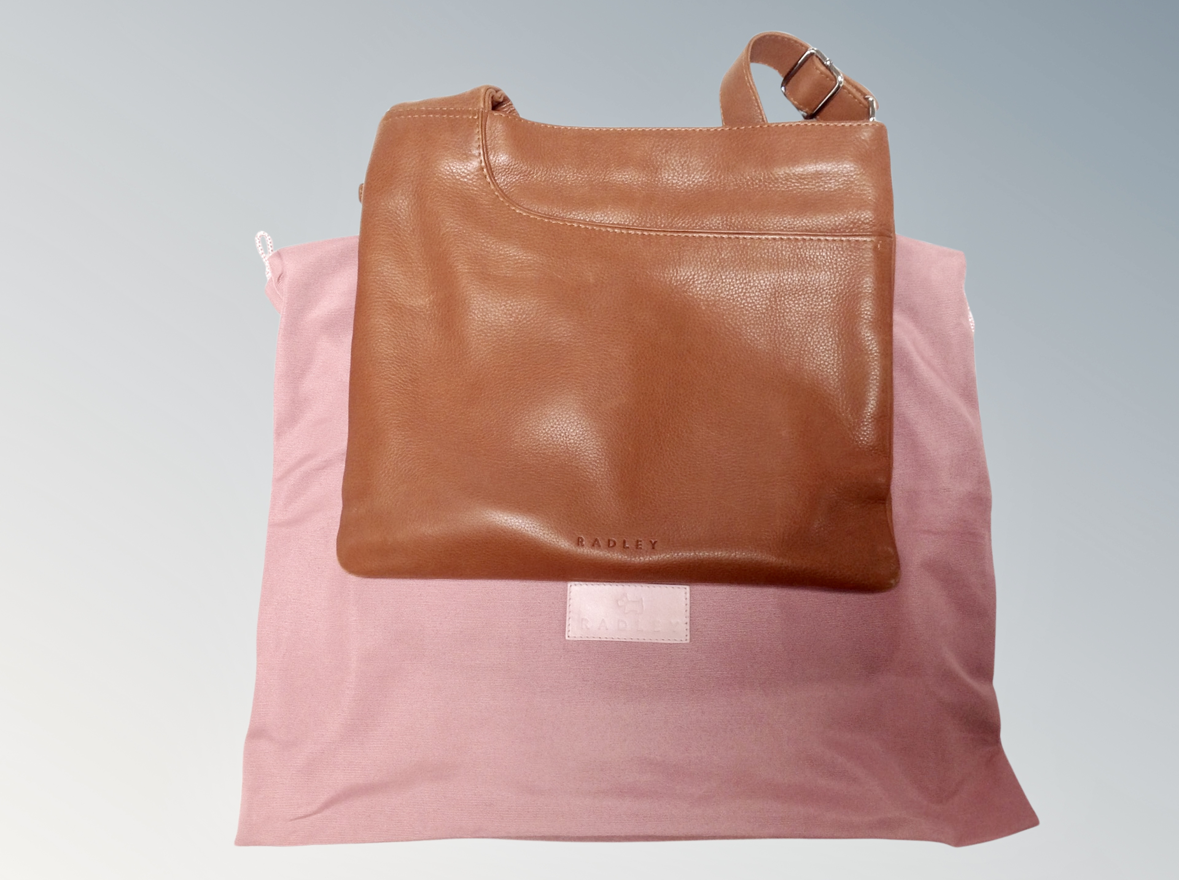 A lady's tan leather Radley shoulder bag together with a further example in olive leather,