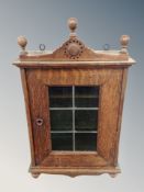 An oak leaded glass wall cabinet,