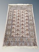 An Iranian fringed rug on beige ground 170 cm x 96 cm