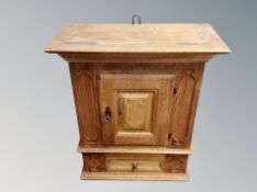 An oak single door wall cabinet,