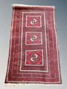 An Afghan rug on red ground 142 cm x 82 cm