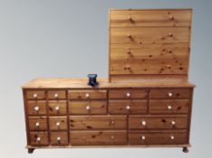 A pine eighteen drawer chest fitted with a vice together with a further pine chest of four drawers