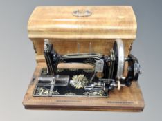 An antique sewing machine in box