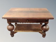 An oak coffee table on bulbous legs,