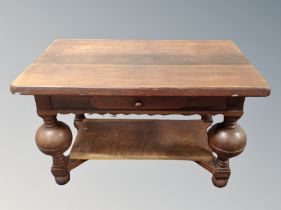 An oak coffee table on bulbous legs,