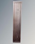 A gun cabinet with two keys, 125cm by 25.5cm by 15.