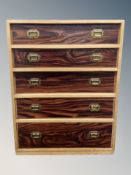 A teak effect five drawer low chest,