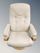 A Scandinavian cream leather swivel relaxer chair