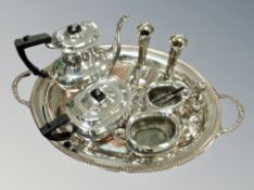 A silver plated twin handled serving tray, diameter 62 cm together with a four piece tea service,