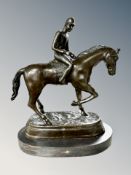 A bronze figure of a jockey on horseback, mounted on marble plinth,