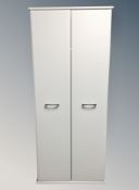 A contemporary white double door wardrobe together with a similar pair of four drawer chests