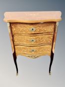 A French Kingwood veneered and inlaid serpentine fronted three drawer chest,