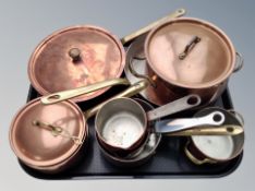 A group of copper and brass kitchen pans