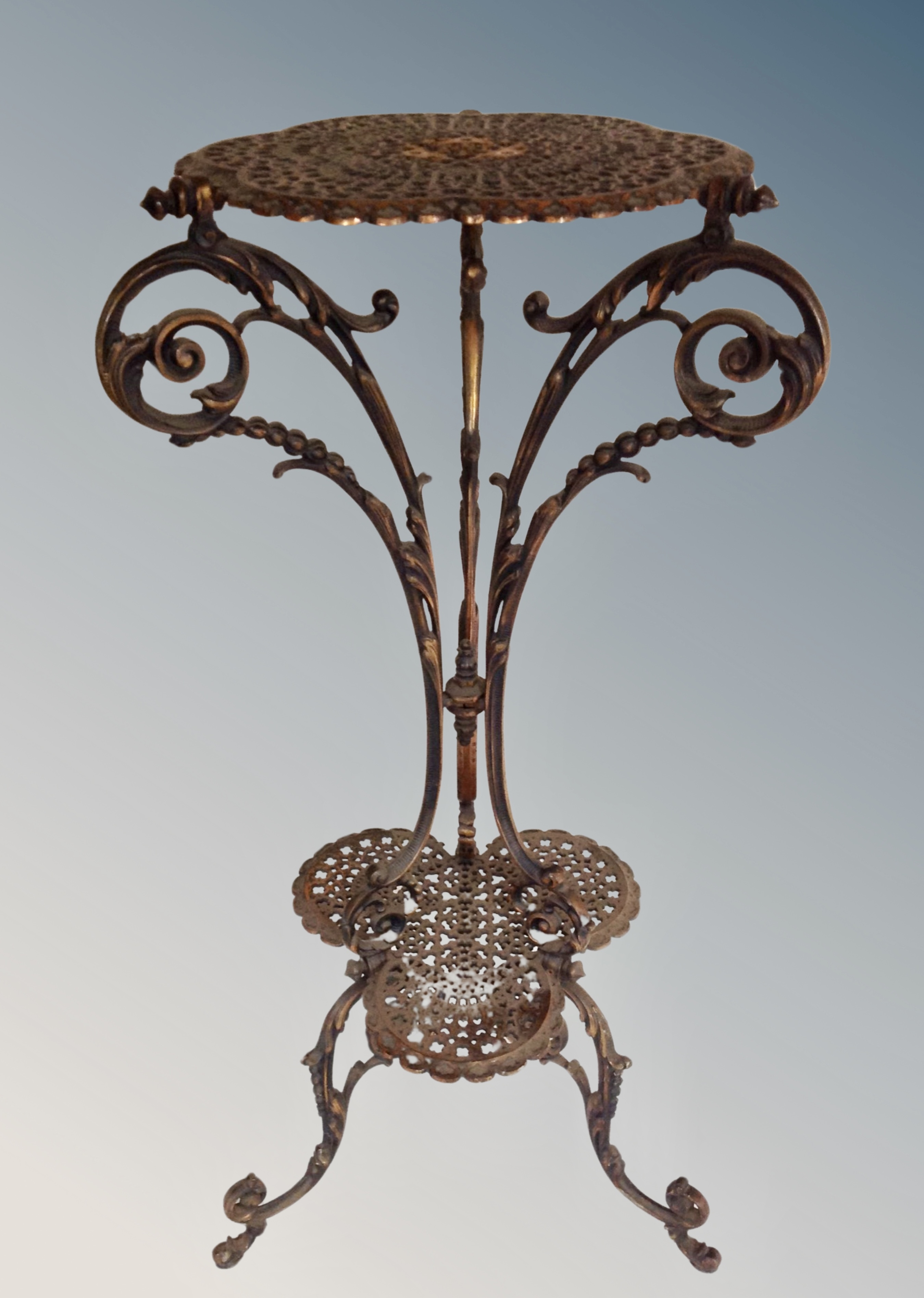 A cast metal two tier jardiniere stand,