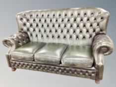 A Chesterfield buttoned leather three seater settee,