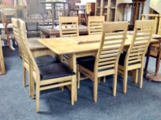 A contemporary oak extending dining table with two leaves,