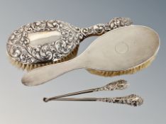 Two silver backed dressing table brushes and two similar button hooks