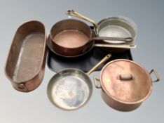 A group of copper and brass cooking pans,