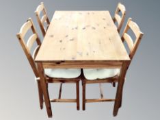 A contemporary pine rectangular kitchen table,