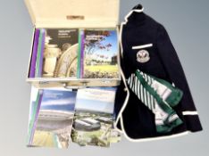 A vintage suitcase and crate containing Wimbledon programmes and related clothing