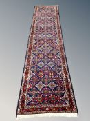 A Feraghan runner, West Iran, with a dense floral lattice on an indigo field,