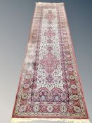 A machine made runner of Persian design 364 cm x 90 cm