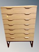 A 20th century teak effect seven drawer chest,