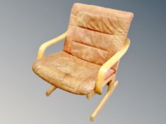 A Scandinavian bentwood armchair with tan leather cushion