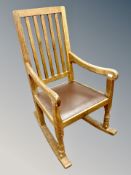 Mouseman : A Robert Thompson English oak rocking chair with studded leather seat, width 52 cm,