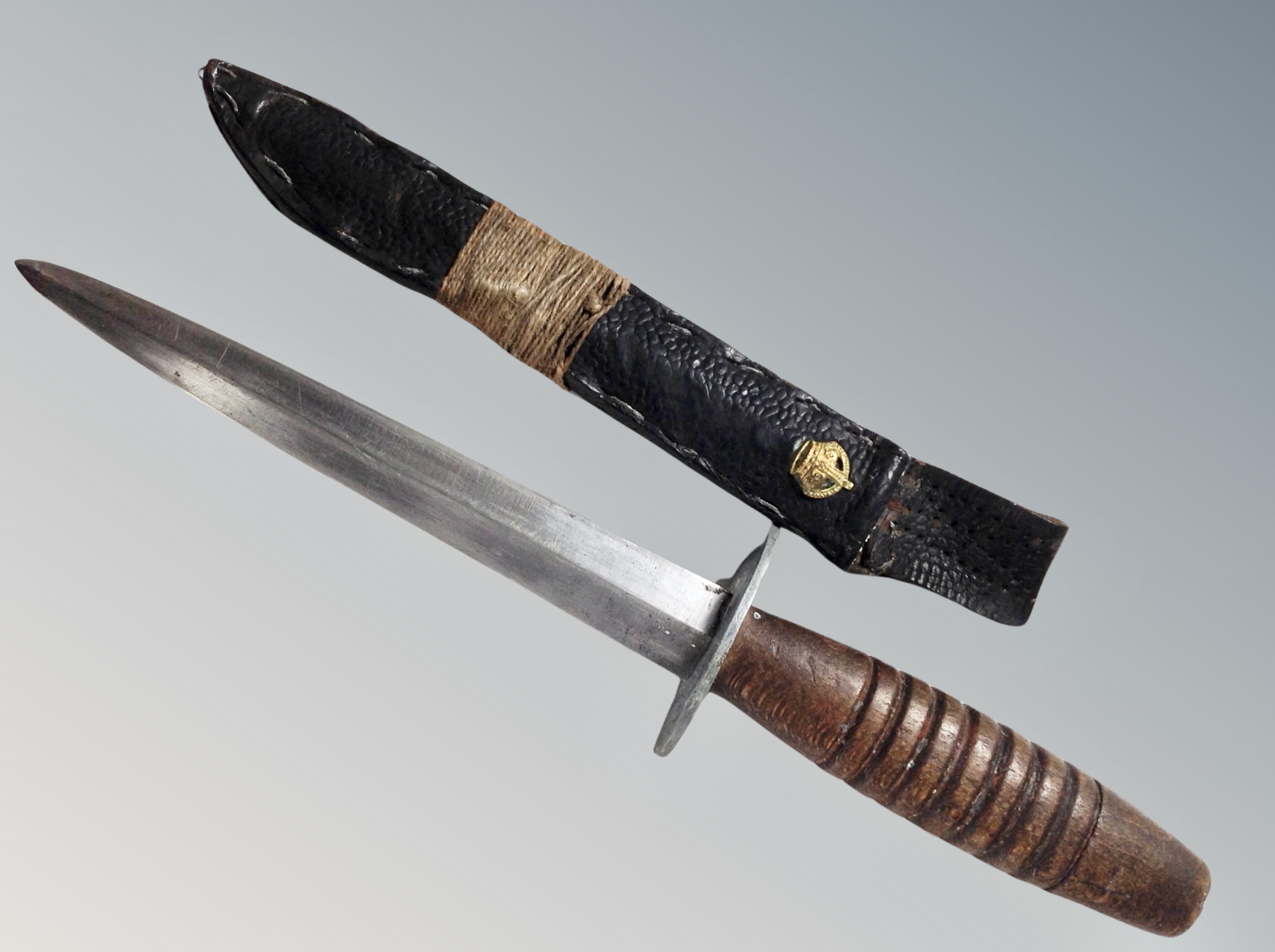 A Fighting style knife in leather sheath