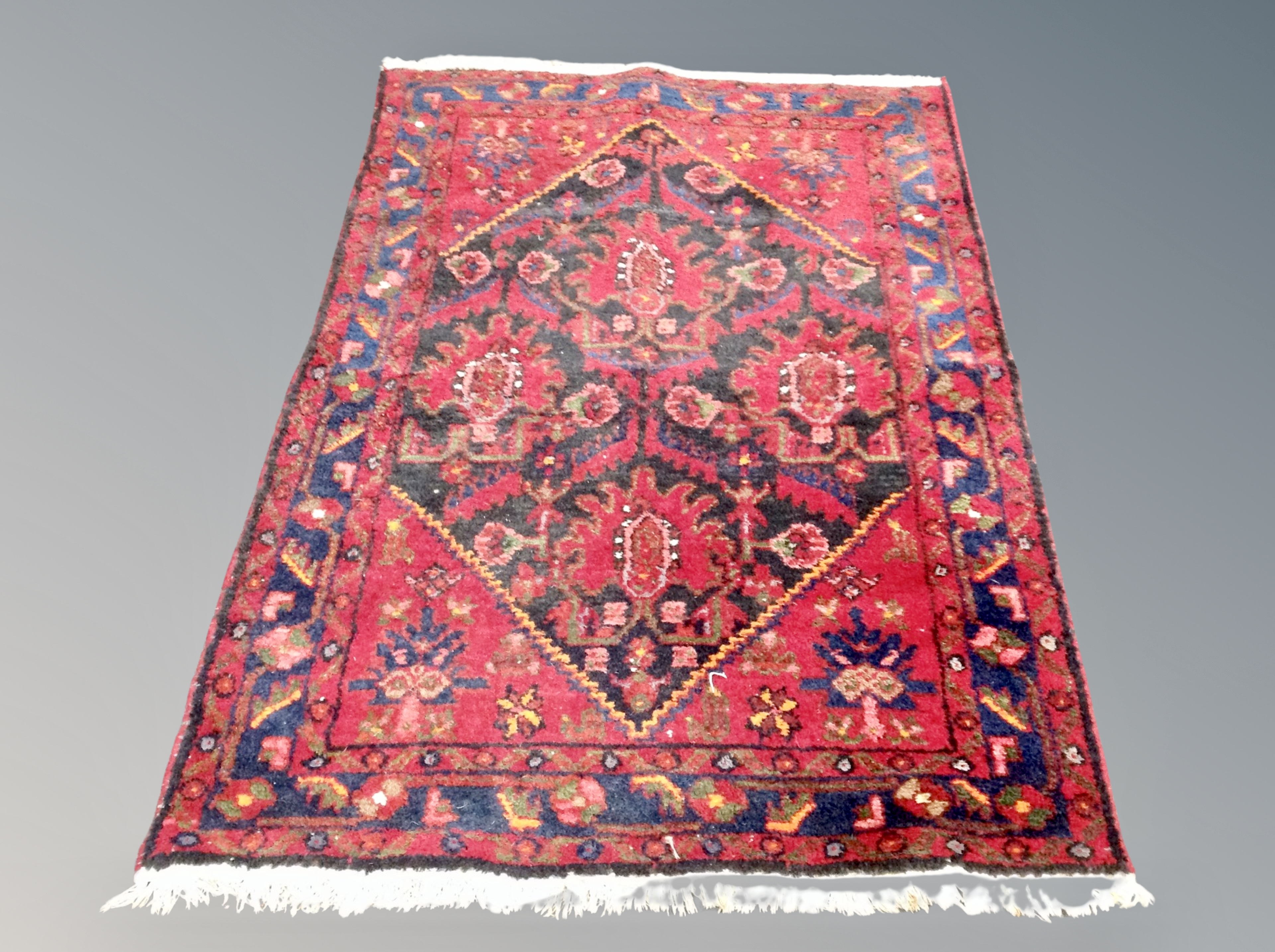 An Iranian Hamadan rug on red ground,