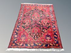 An Iranian Hamadan rug on red ground,