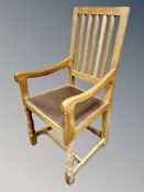 Mouseman : A Robert Thompson English oak chair with studded leather seat and vertical railed back,