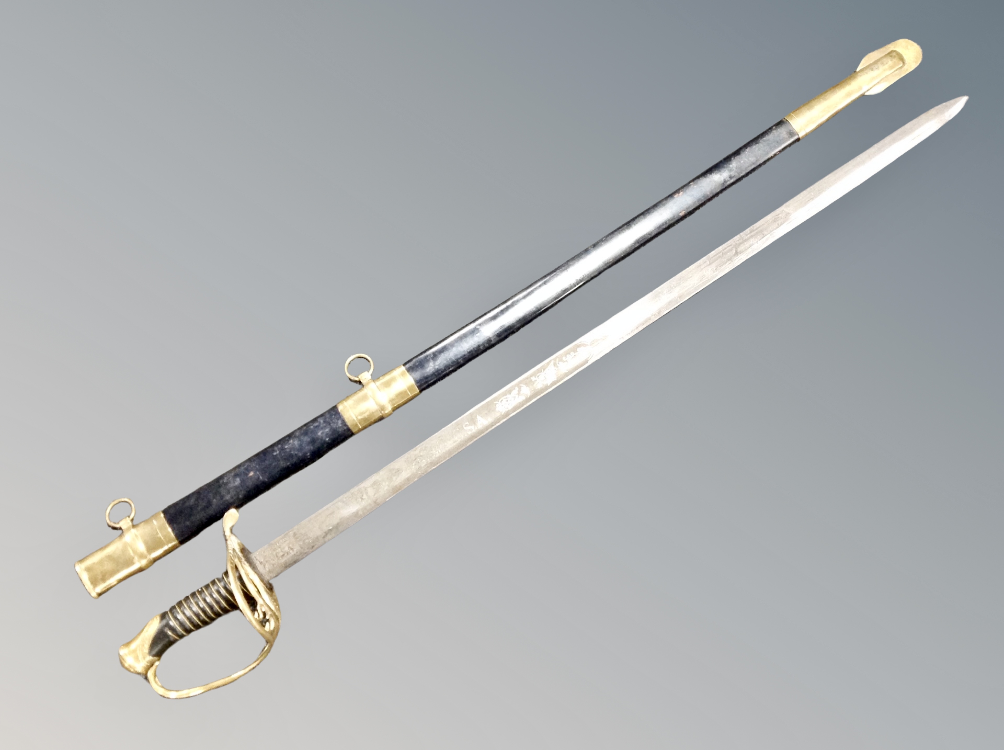 A reproduction cavalry sabre in scabbard together with antique fencing foil