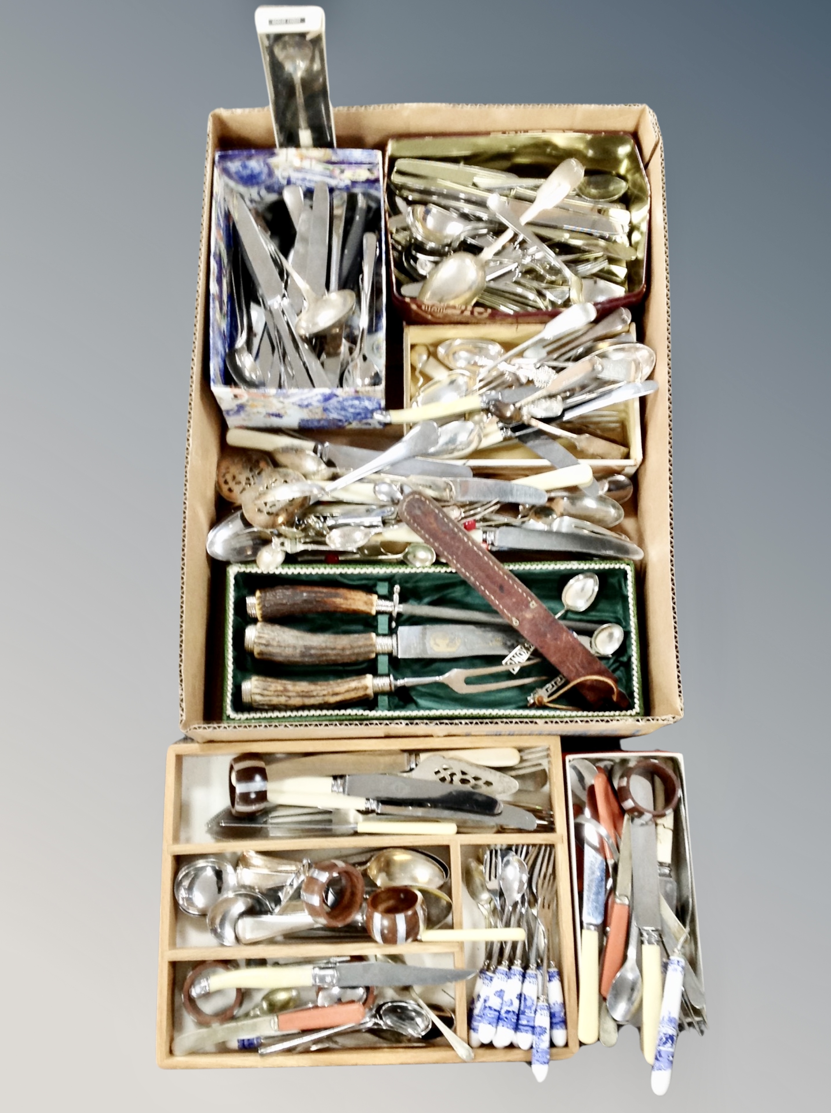 A box and cutlery tray containing assorted flatware,