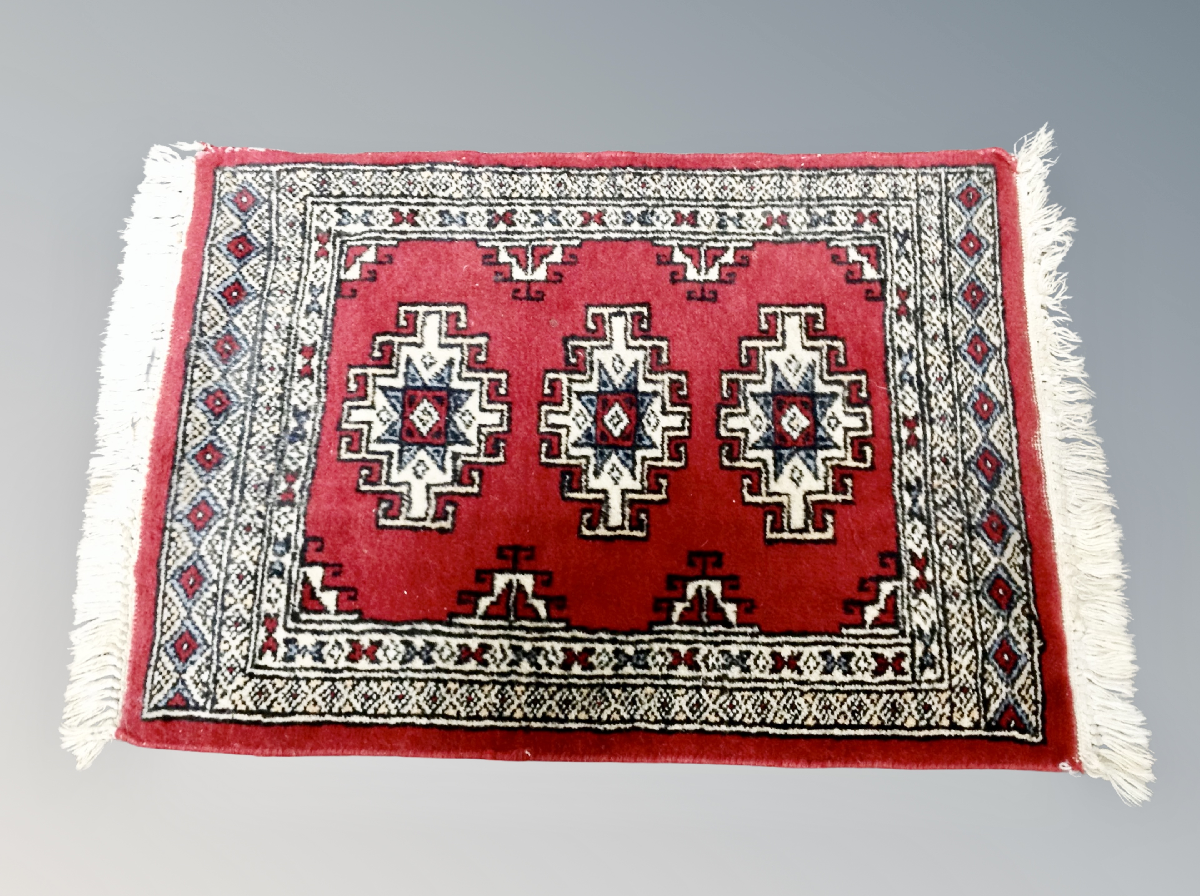A small Iranian hearth rug 72 cm x 46 cm