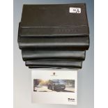 Four Porsche Driver's Manuals/Owner Booklets in Original Black Wallets