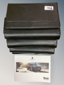 Four Porsche Driver's Manuals/Owner Booklets in Original Black Wallets