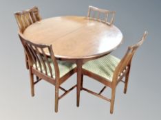 A reproduction mahogany extending dining table and four chairs