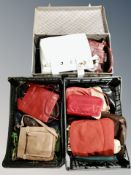 Two crates of lady's handbags and vintage suitcase