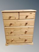 A contemporary pine chest of five drawers,