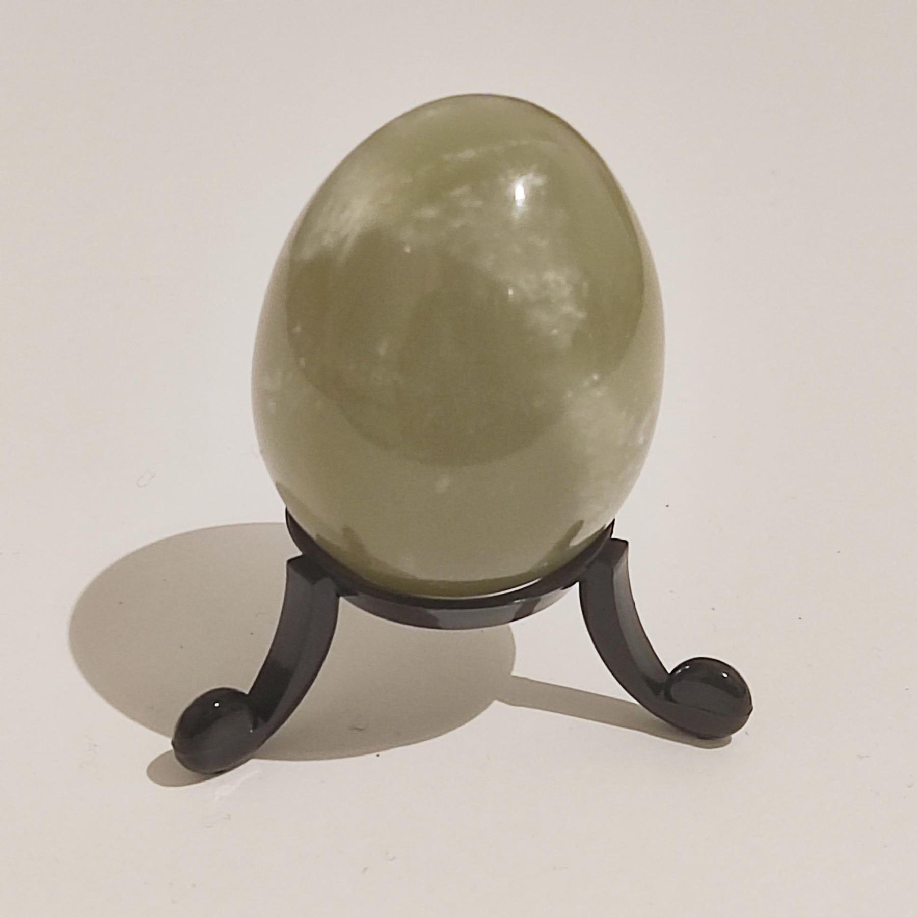 A Nephrite jade egg from Brazil, no stand included, and a Chalcedony stalacite crystal from Peru.