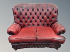 A Chesterfield oxblood leather two seater settee,