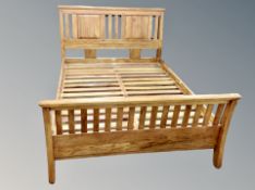 A contemporary stained oak 5' bed frame