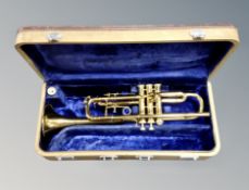 A brass trumpet stamped W09434 in fitted case