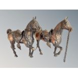 Two patinated metal figures of horses,