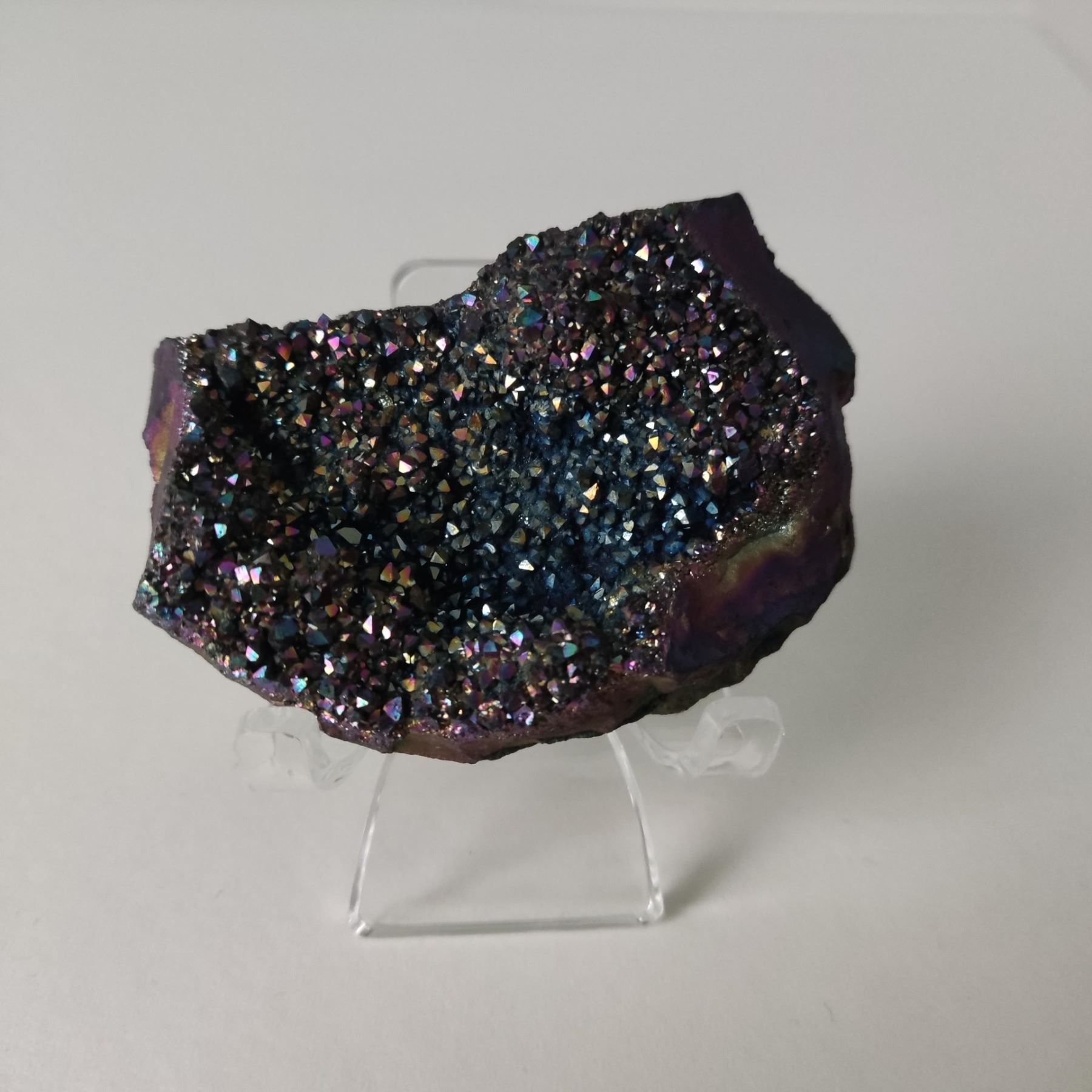 A Titanium aura amethyst rainbow crystal from Namibia and a purple agate slice from Mexico.