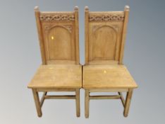 A pair of ecclesiastical oak chairs