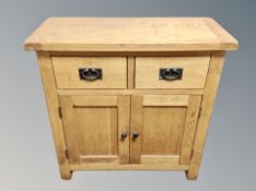 A contemporary solid oak two door side cabinet