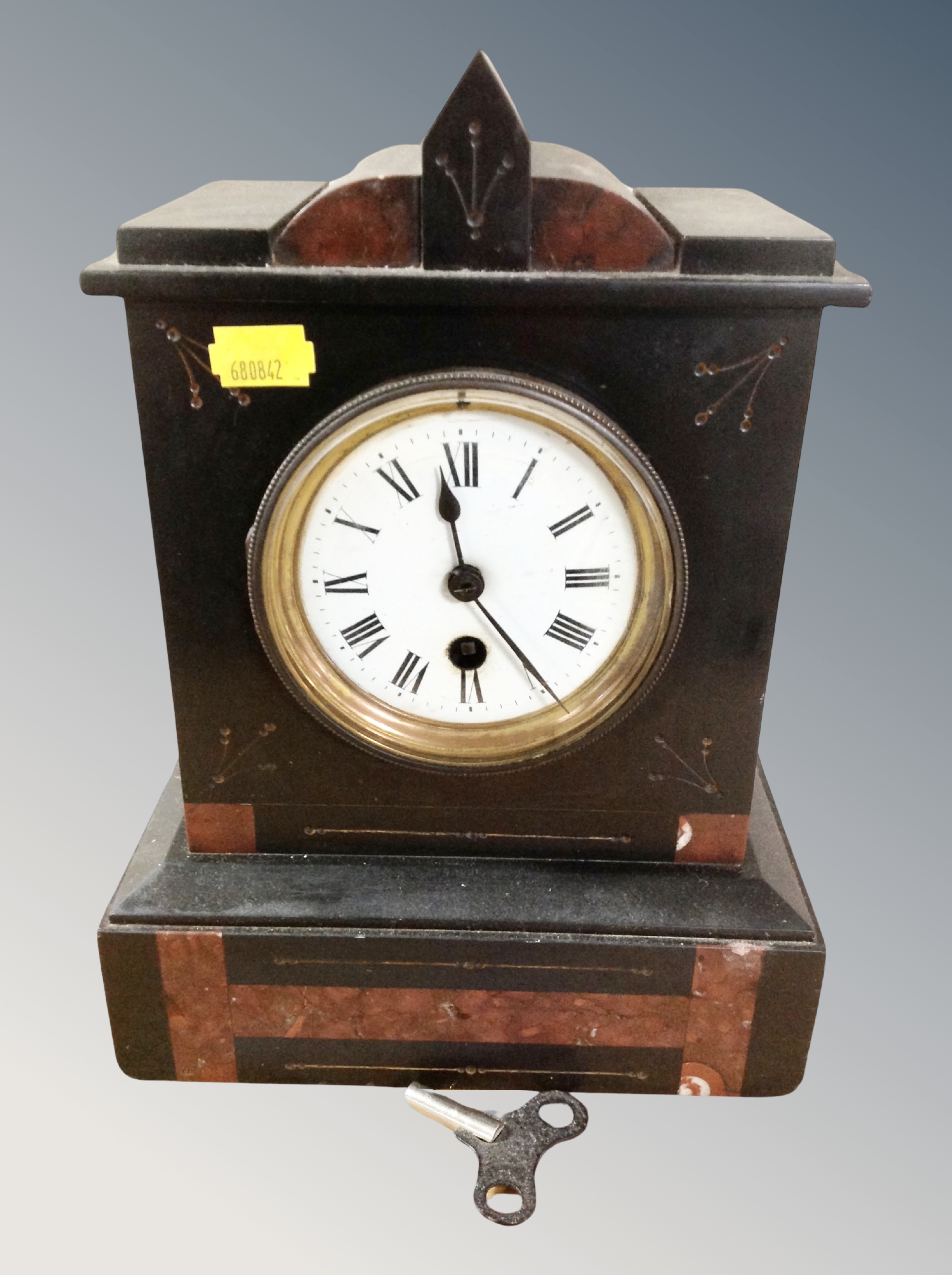 A Victorian black slate and marble mantel clock